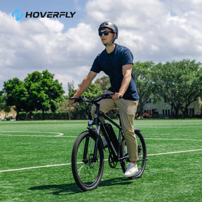 Hoverfly Ourea E-Bike Rider Enjoying a Green Ride Across a Football Field.