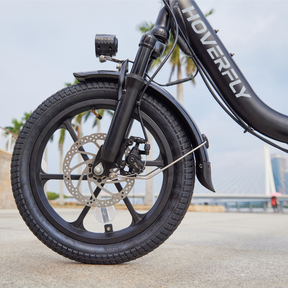Detailed Shot of Front Wheel Assembly on Black Hoverfly H3 Foldable Electric Bike, Showcasing Precision Engineering & Durability.